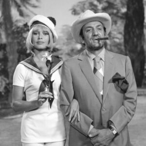 2138277 Boulevard of rum; (add.info.: Boulevard du rum by Robert Photographie en noir et blanc du film Boulevard du Rhum montrant Lino Ventura avec un cigare à la bouche et brigitte bardot en marin qui le tient par le bras