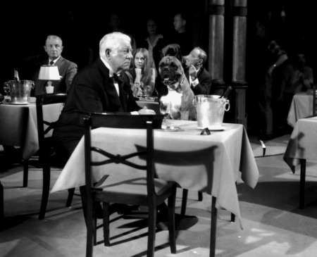 Affiche Jean Gabin Du rififi à Paname : photographie d'art en noir et blanc de 1966 montrant Jean Gabin en smoking assis à table avec un bulldog dans un cabaret parisien.